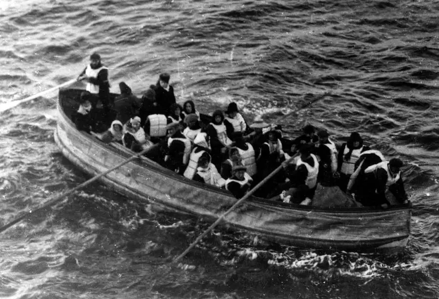 a lifeboat full of survivors wearing lifejackets